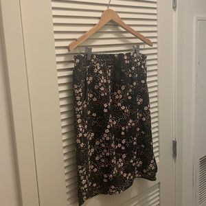 black pencil skirt with light pink flowers. Drawstring & small slits on the side
